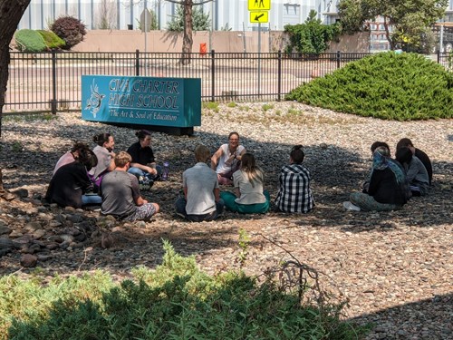 Students gather outside to discuss charter school frequently asked questions